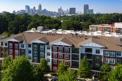 a row of apartment buildings with the atlanta skyline in the background